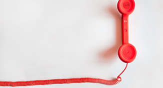 Image of A red desktop phone handle